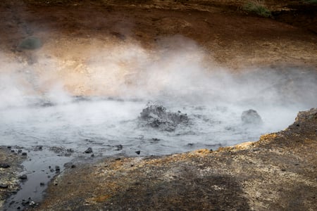 An immense puddle of mud is steaming and boiling in Seltún Hot Springs