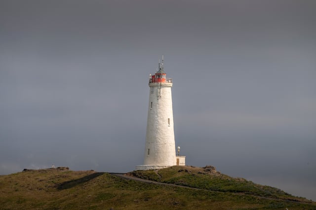 A beautiful lighthouse, standing on the top of a hill