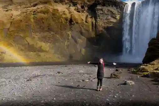 Happy client in front of Skógafoss