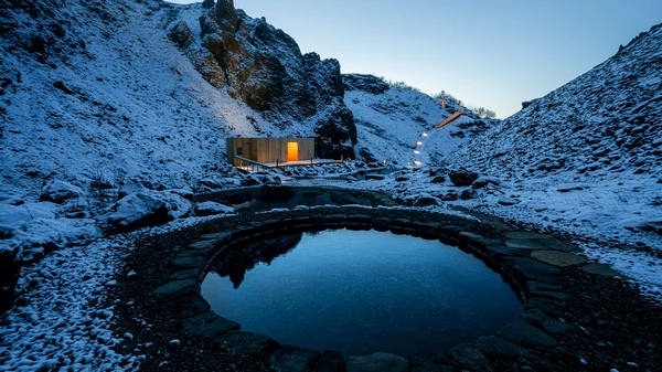 Húsafell Canyon Baths nestled in dramatic canyon setting with mountain views